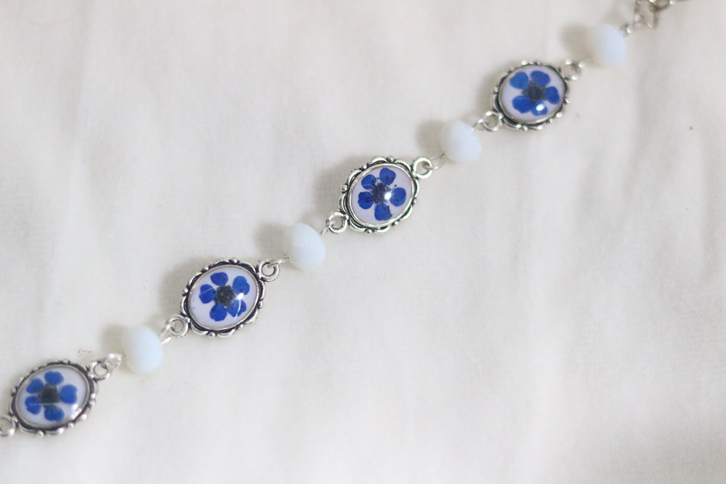 "Elegant Blue Flower Bracelet with Silver Chain & White Glass Beads"