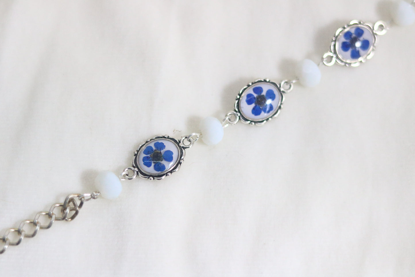 "Elegant Blue Flower Bracelet with Silver Chain & White Glass Beads"