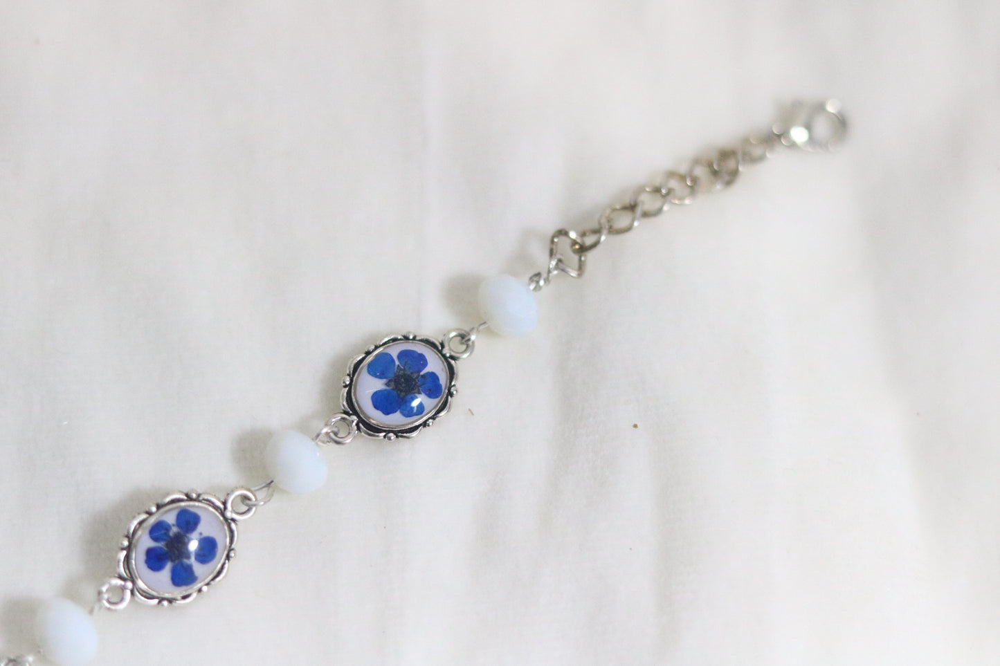 "Elegant Blue Flower Bracelet with Silver Chain & White Glass Beads"