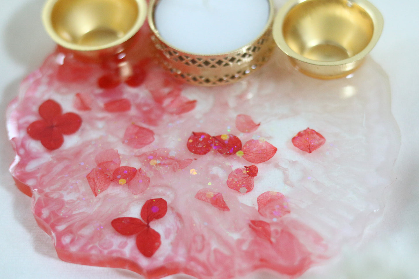 "Resin Pooja Thali with Delicate Floral Accents and Golden Diyas"